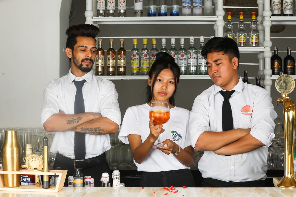 Three Encore bartenders behind the bar
