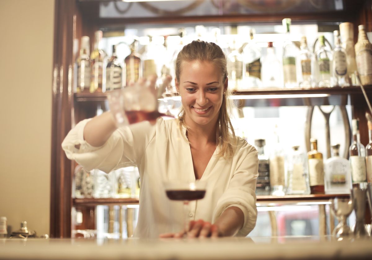 Bartender serving cocktails at an event bar
