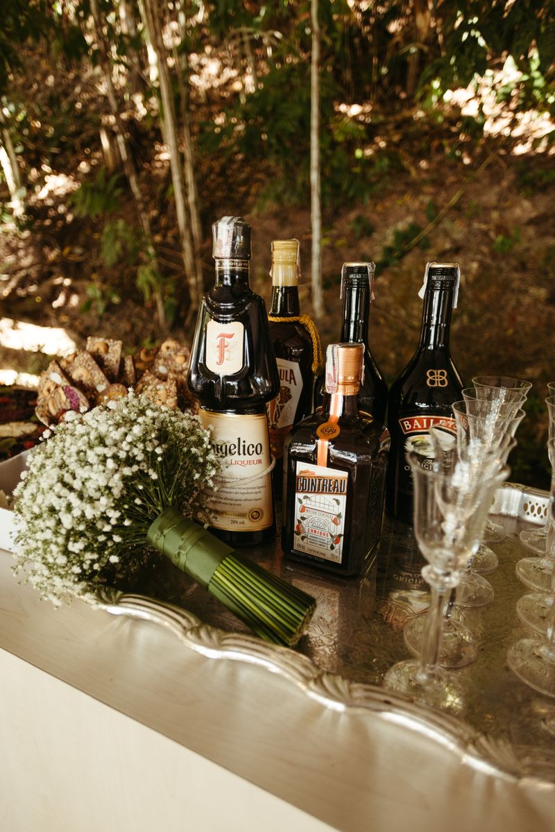Small outdoor bar tray with bottles and flowers